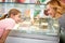 Woman and girl consulting about selection of ice cream