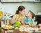 Woman with girl cooking fish dumplings together at home kitchen