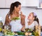 Woman and girl holding salad