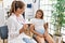 Woman and girl pediatrician and patient having medical consultation at clinic