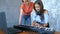 Woman and girl playing midi keyboard and laptop together in studio