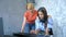 Woman and girl playing midi keyboard and laptop together in studio