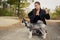 Woman gives a command to her dog puppy Siberian Husky in the autumn park. Dog training