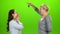 Woman gives the keys to her daughter. Green screen. Side view