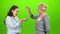 Woman gives the keys to her daughter. Green screen. Side view