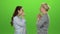 Woman gives the keys to her daughter . Green screen. Side view. Slow motion