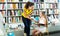 Woman giving book to little girl