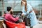 Woman giving a drink to a homeless beggar