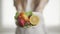 A woman is giving the fresh fruits on plate. Closeup. Healthy eating and dieting. Vegetarian food and health concept