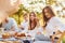 Woman giving high five to photographer. Group of young people have vacation outdoors in the forest. Conception of weekend and