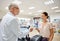 Woman giving money to pharmacist at drugstore