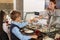 Woman giving plate with healthy food to boy in canteen