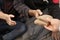 Woman giving poor homeless people pieces of bread outdoors