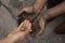 Woman giving poor homeless person money, closeup