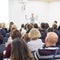 Woman giving presentation on business conference.