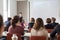 Woman giving presentation in lecture hall at university.