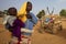 Woman giving water to her baby in Mali
