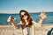 woman with glasses on the beach stretches her hands to the camera landscape sea beach