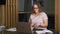 Woman with glasses is sitting at desk and studying at home, communicating with colleagues and friends via video over