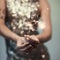 Woman in glitter dress holding sparkler, close up hands, romantic look