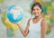 Woman with globe against blurry map