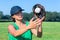 Woman with glove and cap catching baseball