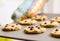 Woman with gloves holding a baked cookies tray