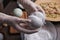 Woman in gloves making bath bomb at table, closeup