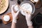 Woman in gloves making bath bomb at wooden table, top view