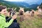 Woman and goats, mountain scenery on background.