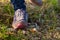 Woman goes on the grass in sneakers. Risk of stepping on a splinter of broken bottle glass.