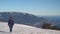 Woman goes on snow-covered mountain plateau