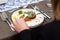 woman is going to eat a herring with potato Kroket croquette Dutchs favourite snack deep-fried ragout filled snack in a