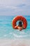 woman going to swim with inflatable ring