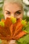 Woman with golden autumn leaf