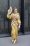 Woman with golden kimono and fan before Gucci fashion show, Milan Fashion Week street style