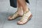Woman with golden reptile leather sandals before Emporio Armani fashion show, Milan Fashion Week