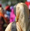 Woman with golden veil during a religious event on the roads of