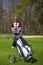 Woman at the golf range with trolley bag