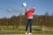 Woman golfer hitting the golf ball