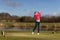 Woman golfer hitting a golf ball on the fairway