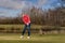 Woman golfer striking the golf ball