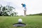 woman golfer teeing golf in golf tournament competition at golf course, selective focus on golf ball