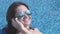 Woman in good mood talking on phone, reflection in sunglasses