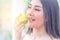 Woman with good shape eating green apple for healthy food and lifestyle concept