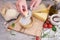 Woman grates Parmesan cheese on a wooden cutting board at domestic kitchen