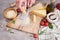 Woman grates Parmesan cheese on a wooden cutting board at domestic kitchen