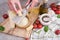 Woman grates Parmesan cheese on a wooden cutting board at domestic kitchen