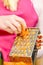 Woman grating carrot on metal grater