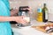 Woman grating a wedge of cheese for a recipe